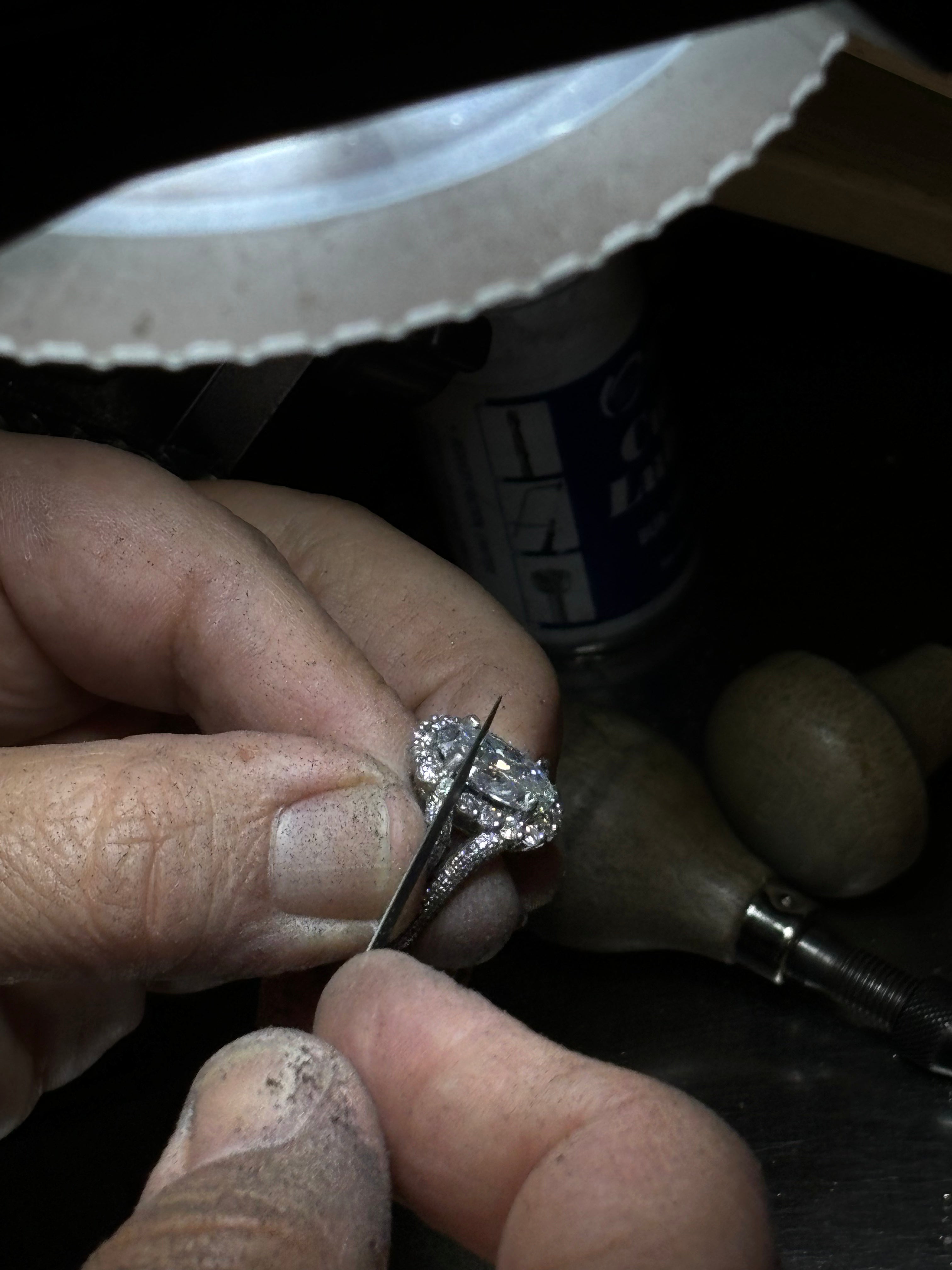 working on engagement ring, at the jeweler's bench