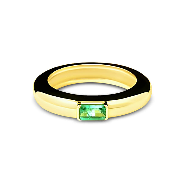 Gold ring with a green gemstone on a white background